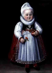 Retrato de un niño pequeño sosteniendo una manzana y una flor
