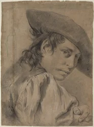 Un joven con sombrero de ala ancha