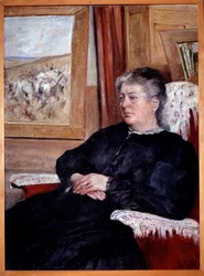 Una anciana en un sillón con un vestido negro