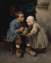Un niño alimentando a su hermanita