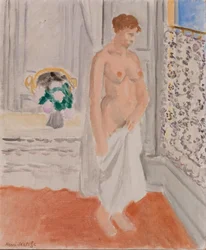 Desnudo de pie cerca de una ventana