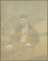 [Retrato de un hombre sentado con gorra]