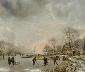 Holandés: Paisaje invernal con adoquines Vista de un canal en invierno