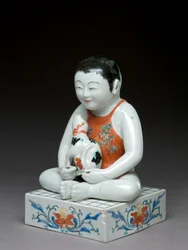 Niño con un perro sentado en una mesa shogi cuadrada, Kakiemon, Japón, 1680-1700
