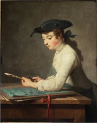 Joven caricaturista tallando su lápiz