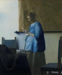 Mujer de azul leyendo una carta
Mujer leyendo una carta