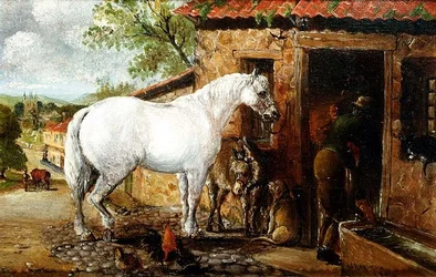 Yegua gris junto a una herrería