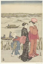 Dos mujeres y un niño en el muelle junto a un río.