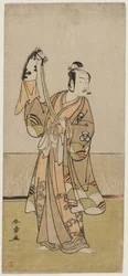 Bando Hikosaburo III sosteniendo una marioneta de mano