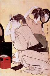 Dos mujeres se arreglan el cabello: una se mira en el espejo mientras la otra se peina. Estampa japonesa de Kitagawa Utamaro (1753-1806). Dimensiones: 0,38 x 0,25 m. 1794-1795. París, Museo Guimet, Museo Nacional de Artes Asiáticas