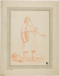 Hombre barbudo de pie sosteniendo un libro