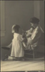 [Madre en mecedora con niños]