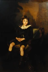 Retrato de un niño sentado de cuerpo entero en una silla