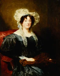 Retrato de una dama, sentada a media longitud, con un vestido azul oscuro y un sombrero de encaje blanco con un lazo azul, sosteniendo una labor de aguja