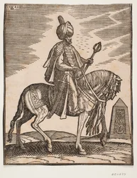 Jinete con turbante con una espada a su derecha y un garrote de guerra en su mano izquierda, perfil hacia la derecha; en el fondo, un obelisco