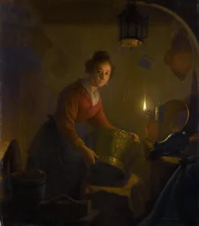 Mujer en una cocina a la luz de las velas