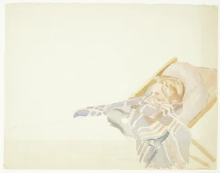 Joven envuelto en una manta, acostado en una tumbona