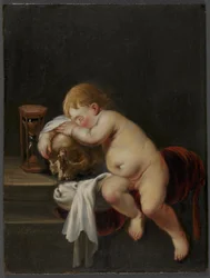 Niño durmiendo sobre una calavera