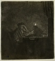Estudiante en una mesa a la luz de las velas