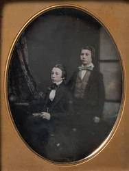 Dos Jóvenes con Corbatas de Moño, Uno Sentado Sosteniendo un Libro, Otro de Pie, 1850s