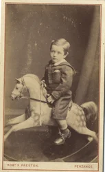 Niño sentado en un caballo de juguete, 1870s