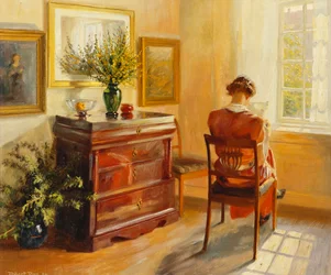 Una mujer leyendo junto a una ventana