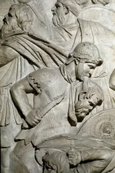 Arte romano: guerrero romano sosteniendo entre sus dientes la cabeza de un guerrero enemigo. Molde de 1862 reproduciendo los bajorrelieves de la columna de Trajano en Roma