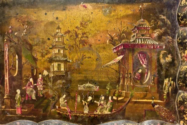 Una mesa de té, detalle de la parte superior donde hay un paisaje con escenas de la vida a imitación de las lacas chinas