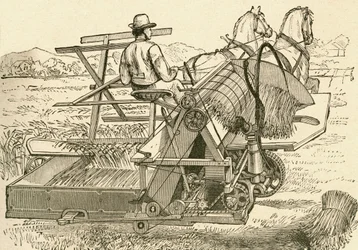 Máquina cosechadora, tirada por caballos, que ataba las gavillas de maíz mecánicamente, utilizada a finales del siglo XIX. Del Museo Popular publicado en Madrid