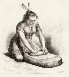 Una mujer nativa de Guayana triturando grano