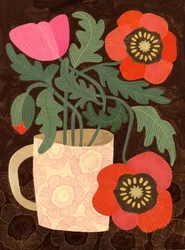 Amapolas en una taza rosa