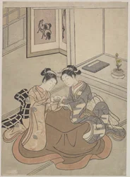 Dos mujeres jóvenes sentadas junto a un kotatsu jugando a la cuerda