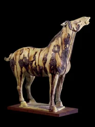 Arte chino: estatuilla funeraria de terracota con esmaltes tricolores que representa un caballo hennin. De la tumba de la Princesa Yong Tai (502-594 d.C.), Chensi. Dinastía Tang (618-907 d.C.)