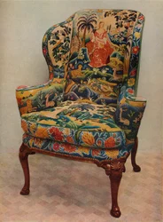 Un sillón tapizado con alas, marco de nogal tallado y cubierta original de bordado de seda, c17