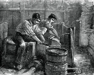 Afiladores trabajando en una rueda, c. 1880