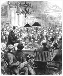 Heinrich Schliemann dando una conferencia en Londres, 1877