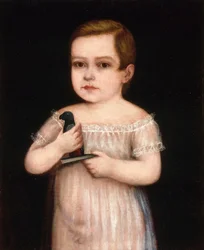 Niño con cotorra de juguete