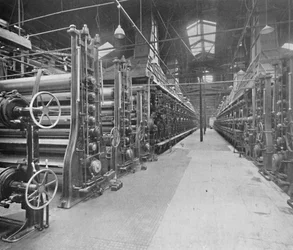 Mostrando dos máquinas de fabricación de tableros e indicando algo de su gran longitud y complejidad, 1