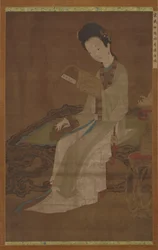 Joven mujer leyendo un libro de poemas, dinastía Ming, siglos XVI-XVII