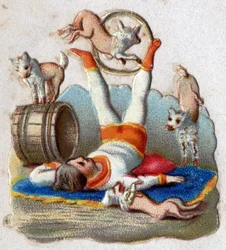 Circo: un domador de animales haciendo trucos con perros, incluyendo uno pasando por un aro. Cromolitografía alrededor de 1890.