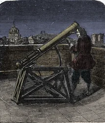 Isaac Newton (1642-1727) físico inglés usando su telescopio