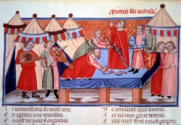 El nombramiento como caballero de Pirro, hijo de Aquiles. Miniatura tomada del «Roman de Troie» de Benoît de Sainte-Maure, poeta normando de finales del siglo XII, realizado hacia 1160-1170 para Leonor de Aquitania. Hacia 1300. París, Biblioteca Nacional