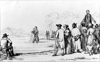 Bautismo de los anabaptistas con inmersión total en agua.