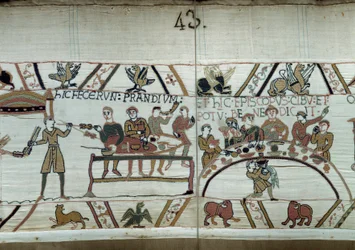 Desembarques en Inglaterra, las armas de Guillermo el Conquistador (1027-1087) hacen una fiesta mientras esperan para luchar contra las armas sajonas de Harold II. Guillermo está rodeado por Barones y el Obispo Odon. Detalle del Tapiz de Bayeux o Bordado d
