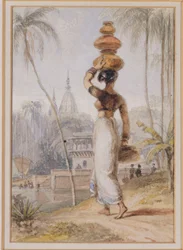 Una mujer hindú llevando una vasija de agua