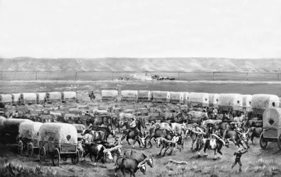 Bueyes siendo uncidos en un corral de carretas cubiertas en una pintura de W. H. Jackson, Scotts Bluff, Nebraska: c. 1875